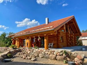 Außenansicht vom Naturstammhaus Rügen mit Terrasse und massiver Rundholzbauweise
